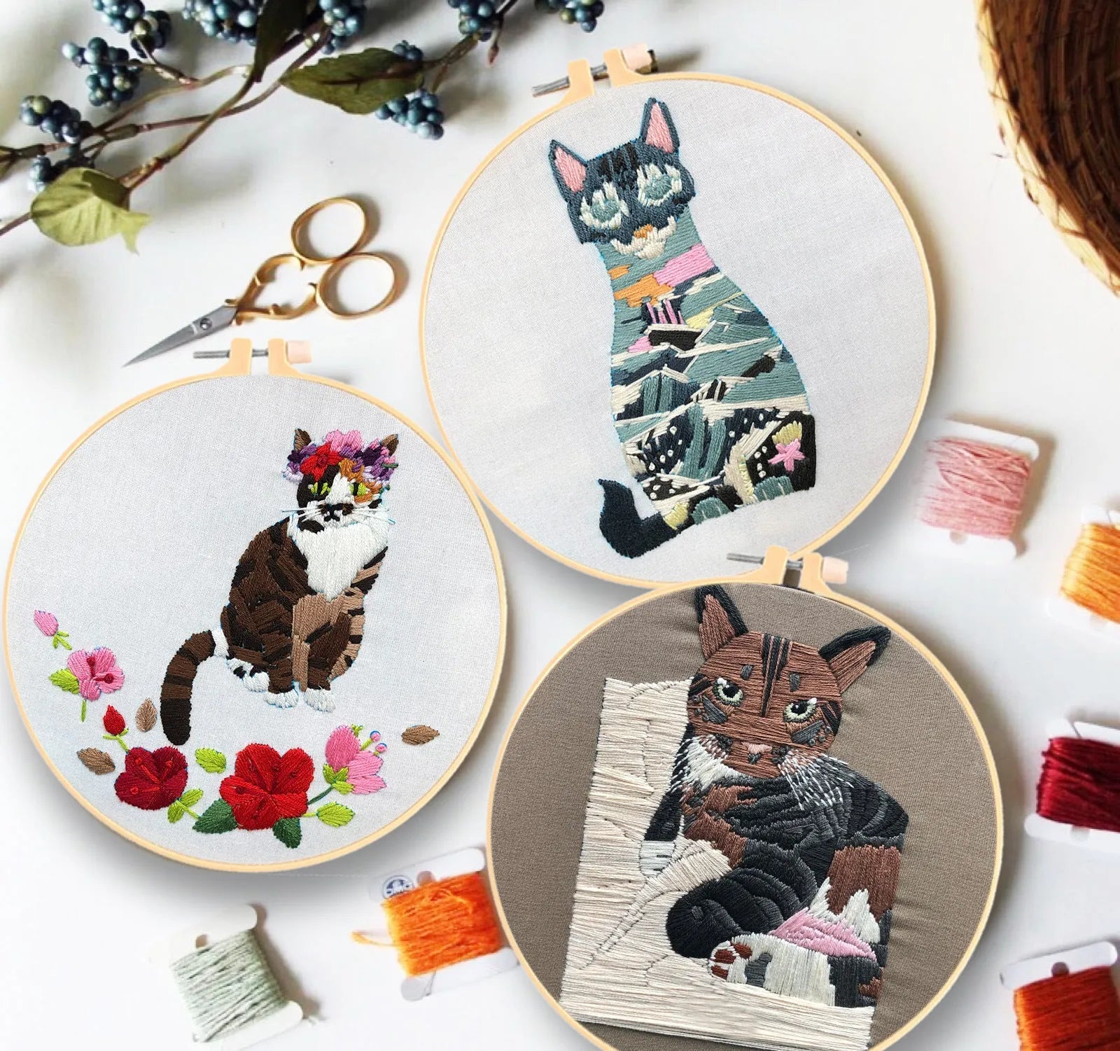 DIY embroidery kit components showing cotton fabric, coloured threads, and hoop for cat designs