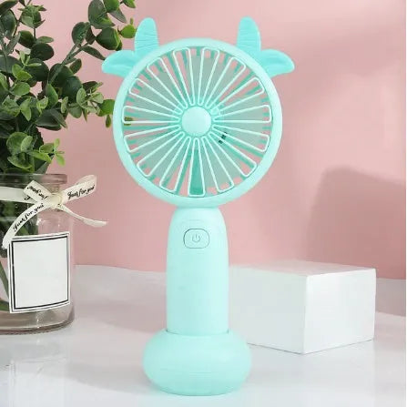 Blue hand-held USB charging mini fan with plastic blades on a white background.