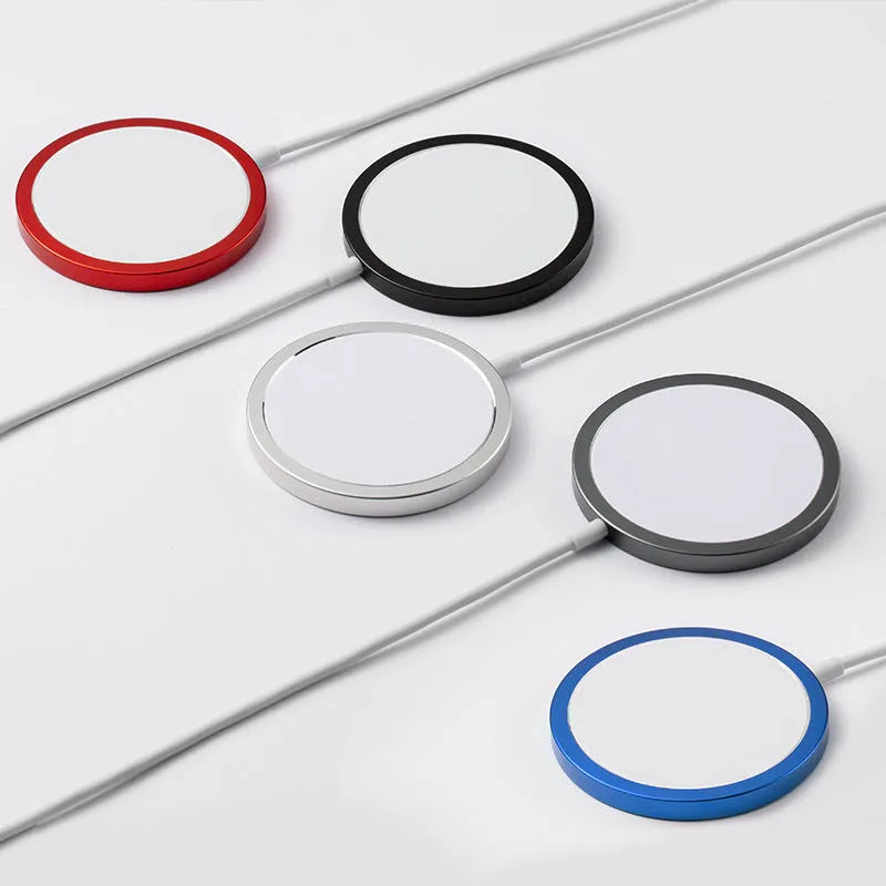 Silver metal Magsafe-compatible magnetic wireless charger for iPhone on a wooden table