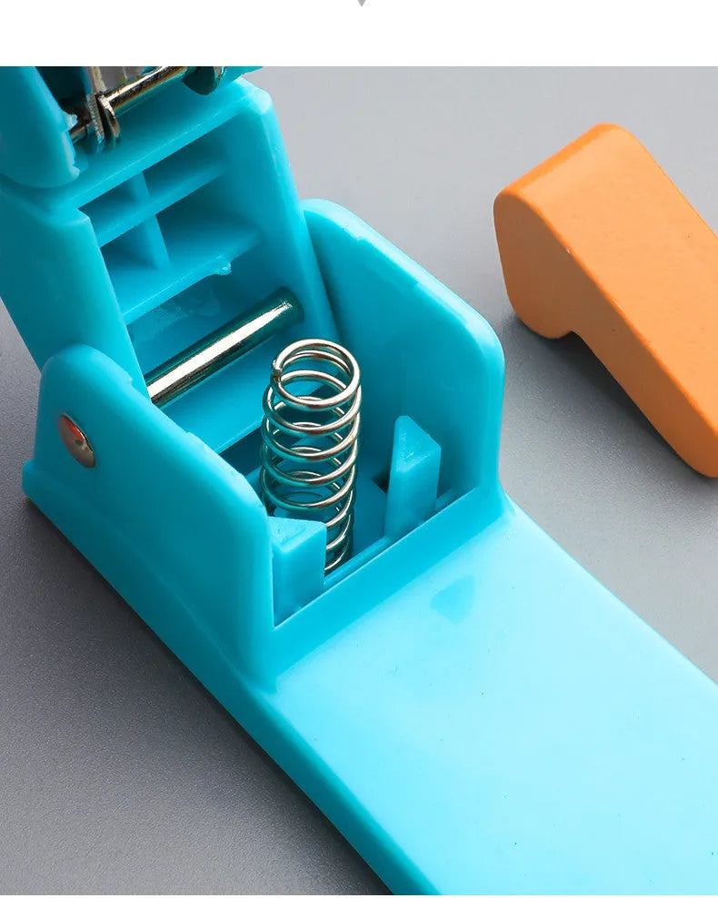 Black rotatable stapler with 360-degree rotating head on a desk next to stacked A4 paper.