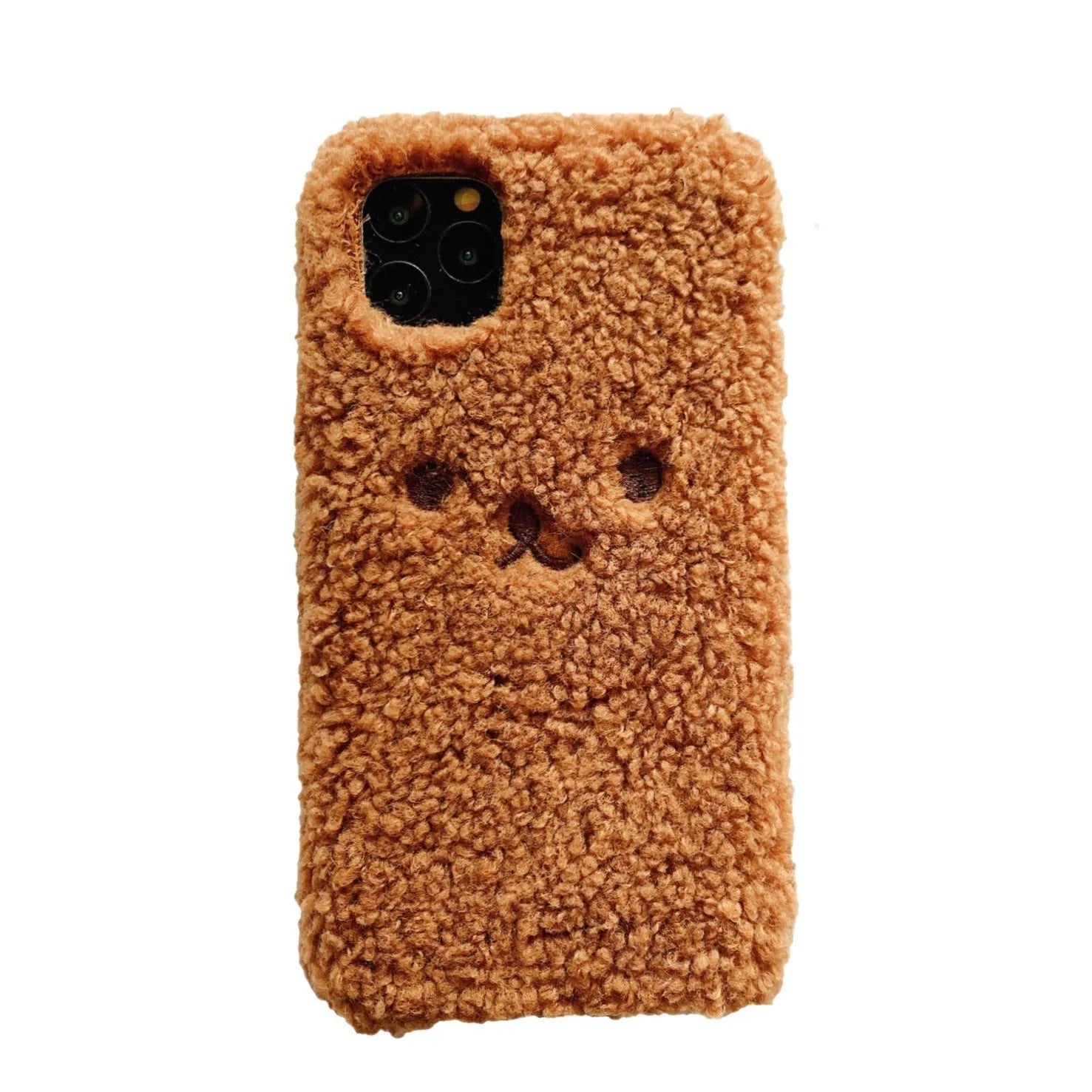 Brown embroidered plush bear face on a clear TPU phone case for iPhone, showing precise button and camera cutouts.