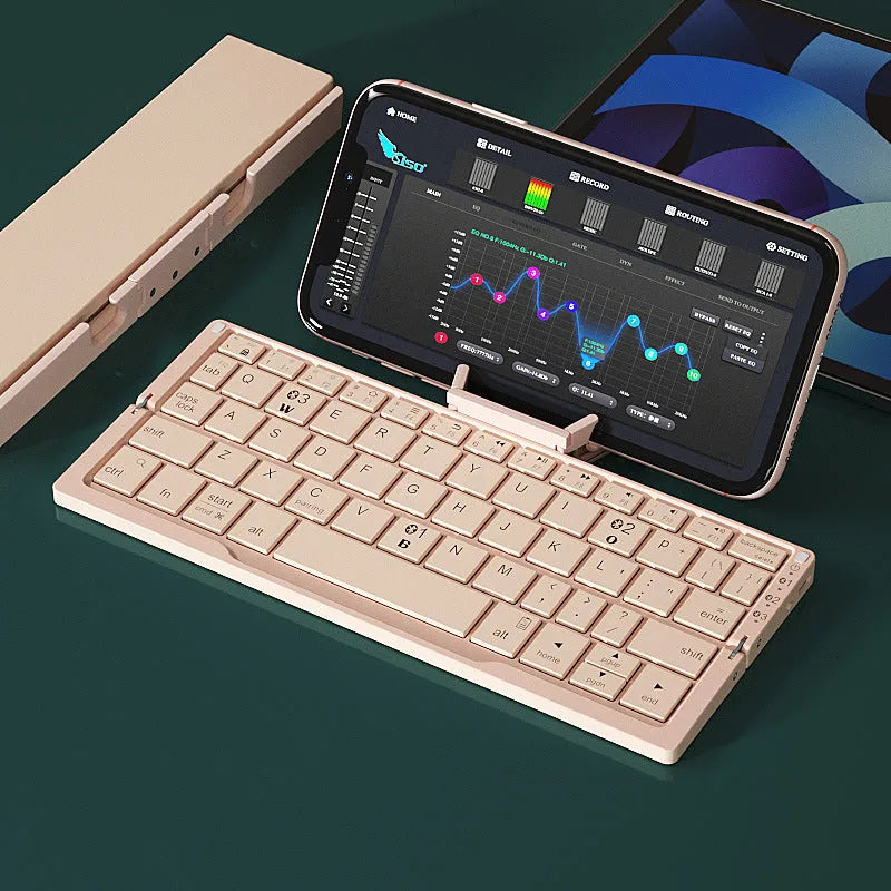 Silver white folding Bluetooth keyboard open with phone in stand next to closed black grey version