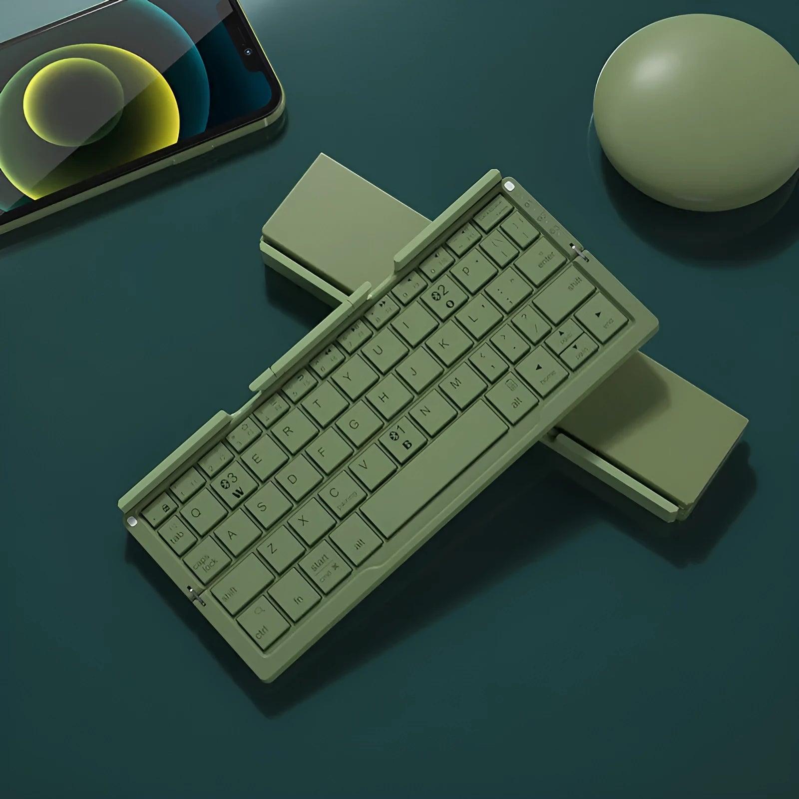 Silver white folding Bluetooth keyboard open with phone in stand next to closed black grey version