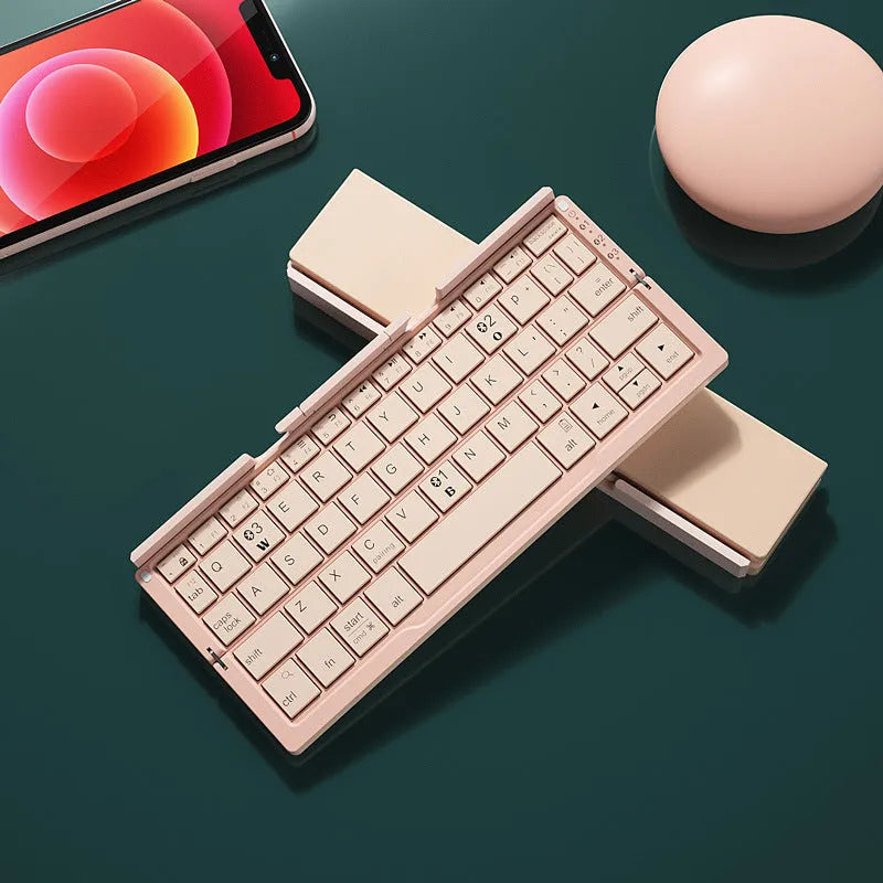 Silver white folding Bluetooth keyboard open with phone in stand next to closed black grey version