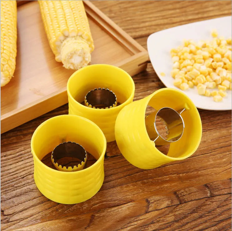 Yellow manual corn grinder thresher with corn-kernel-shaped PP body and stainless steel gear.
