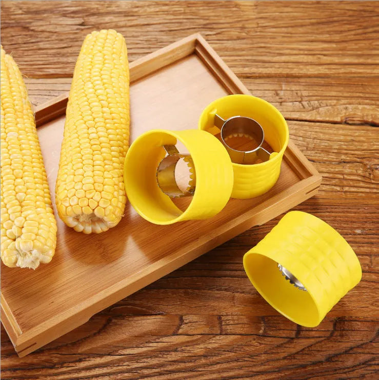 Yellow manual corn grinder thresher with corn-kernel-shaped PP body and stainless steel gear.