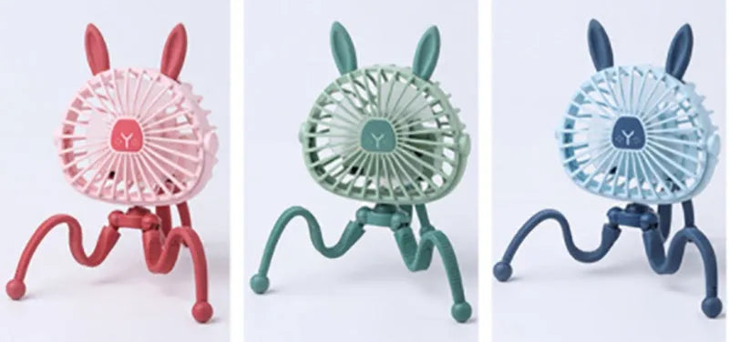 Pink portable USB rechargeable fan with animal design and clip attached to a stroller handle.
