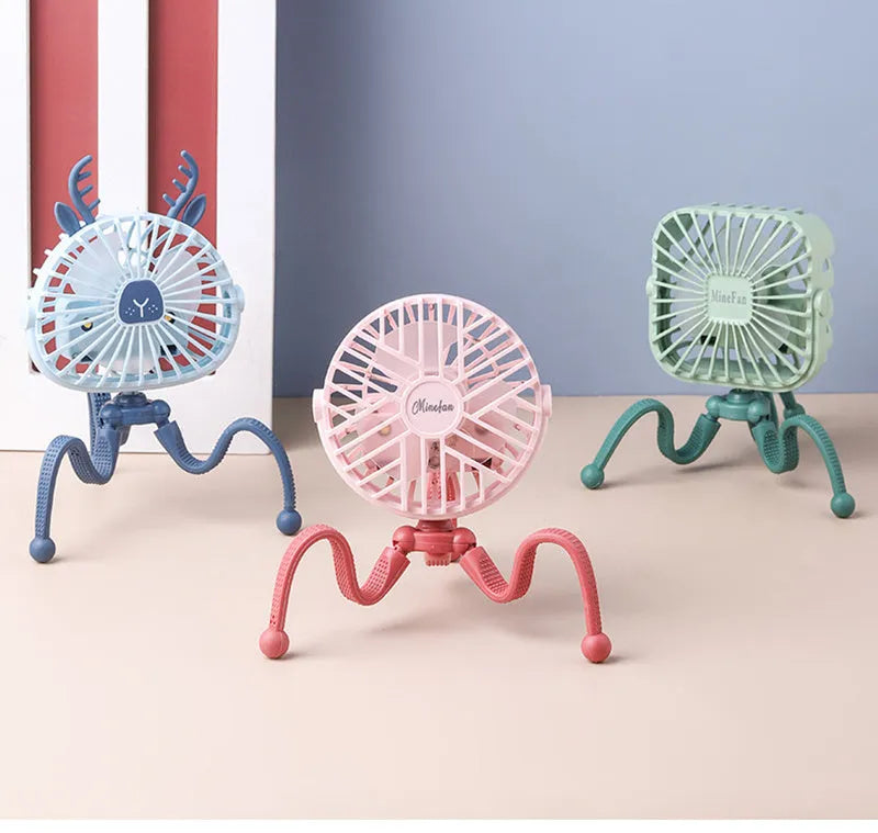 Pink portable USB rechargeable fan with animal design and clip attached to a stroller handle.