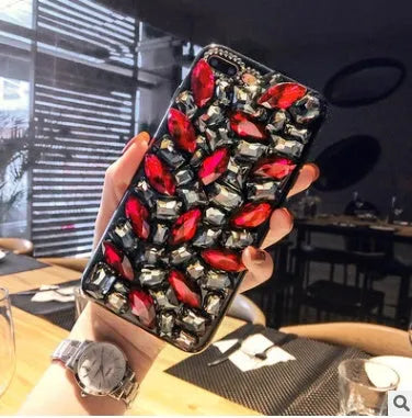 Clear rhinestone sparkle phone case for iPhone on a table, showing soft edges and model-specific fit.