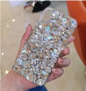 Clear rhinestone sparkle phone case for iPhone on a table, showing soft edges and model-specific fit.