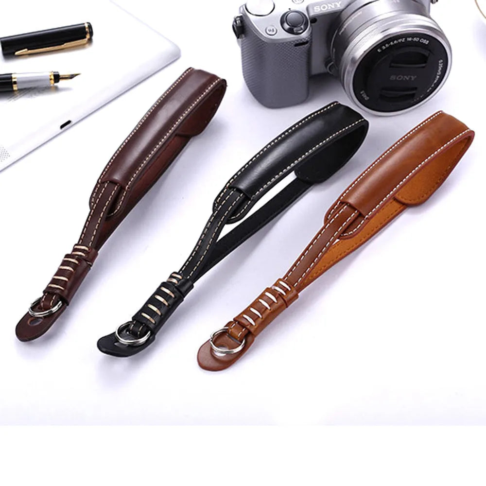 Black adjustable nylon wrist strap with metal quick-release buckle for DSLR and mirrorless cameras.