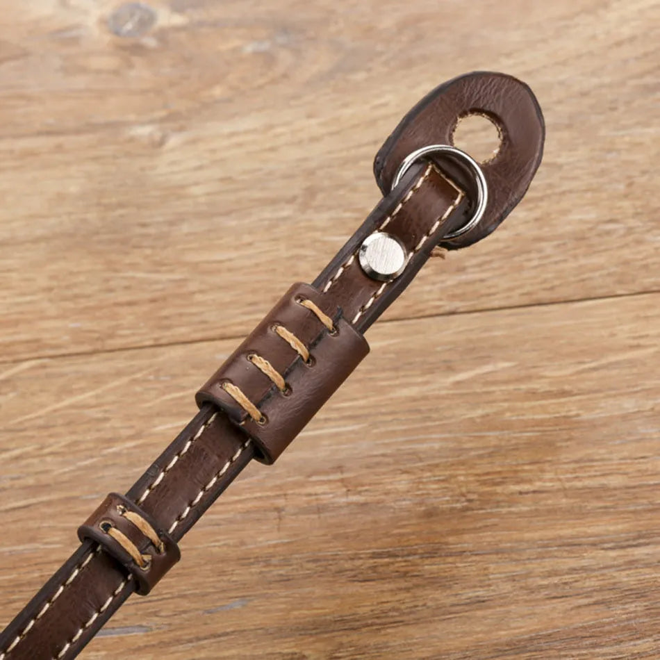 Black adjustable nylon wrist strap with metal quick-release buckle for DSLR and mirrorless cameras.