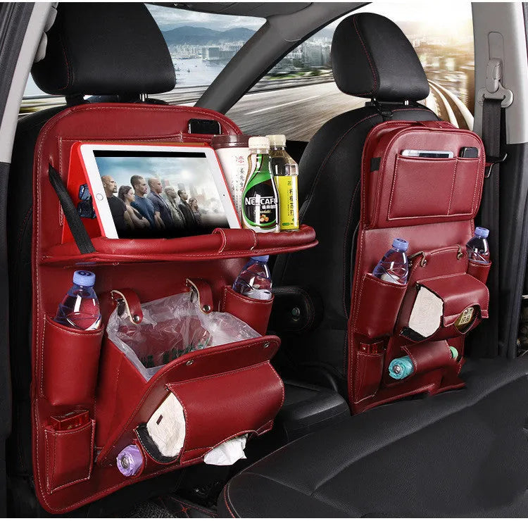 Black PU leather car seat back hanging organiser with pockets mounted on a car headrest.