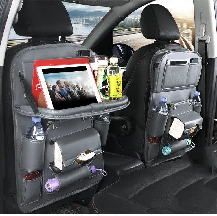 Black PU leather car seat back hanging organiser with pockets mounted on a car headrest.