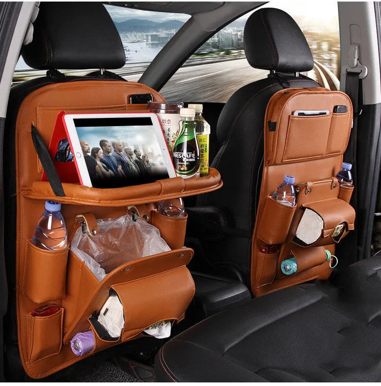 Black PU leather car seat back hanging organiser with pockets mounted on a car headrest.