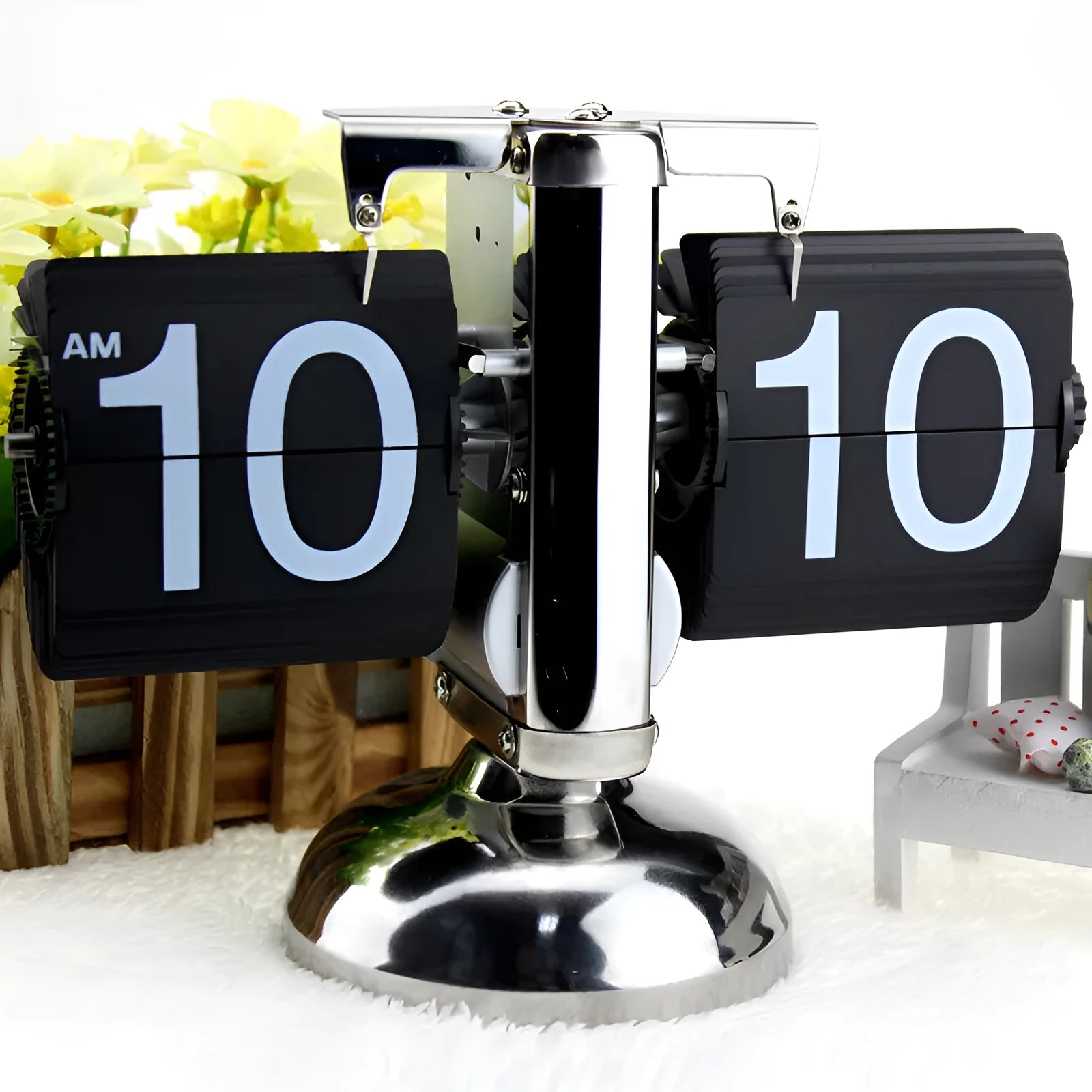 Small scale retro flip clock with black or white trim and black flip cards on a desk