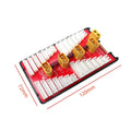 V2 parallel charging board with red PCB, gold connectors, silicone wires, and protective caps for charging multiple LiPo batteries.