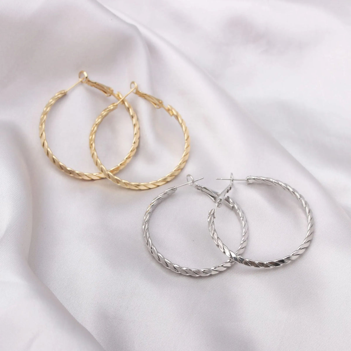 Geometric metal earring for women with electroplated finish, shown in Golden or Silver colour option