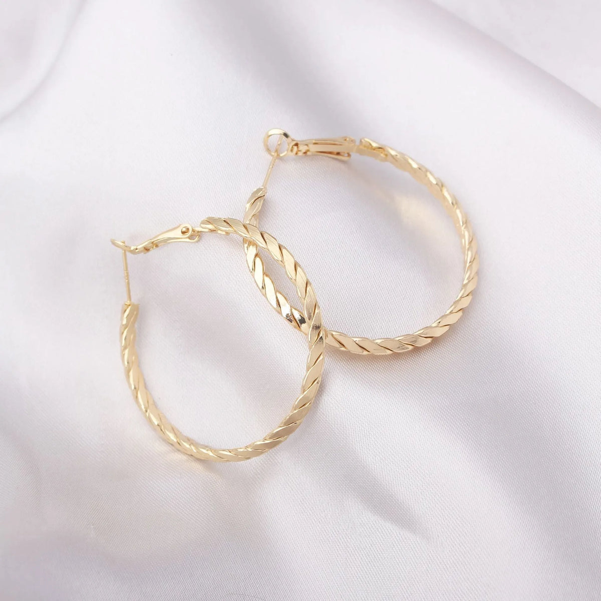 Geometric metal earring for women with electroplated finish, shown in Golden or Silver colour option