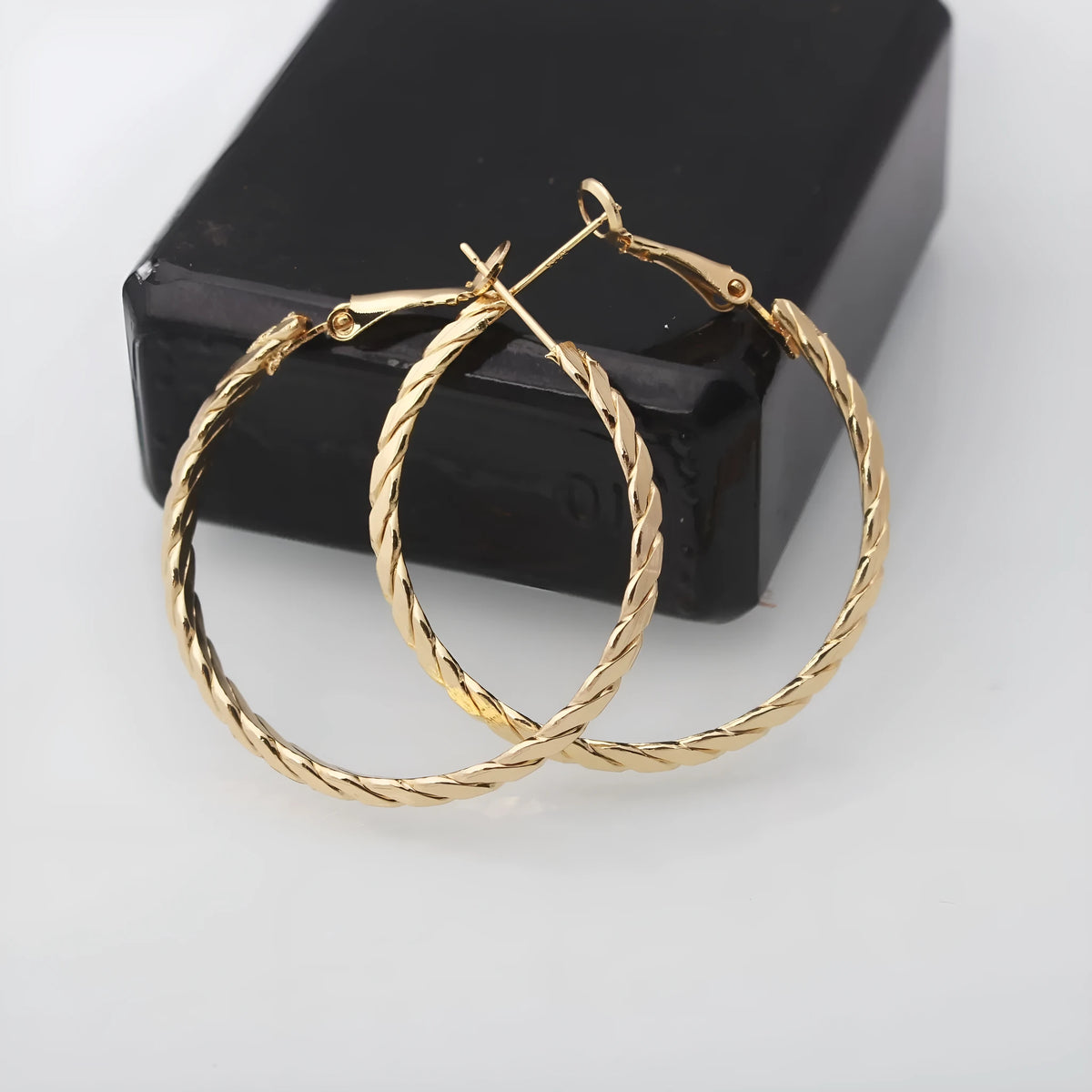 Geometric metal earring for women with electroplated finish, shown in Golden or Silver colour option