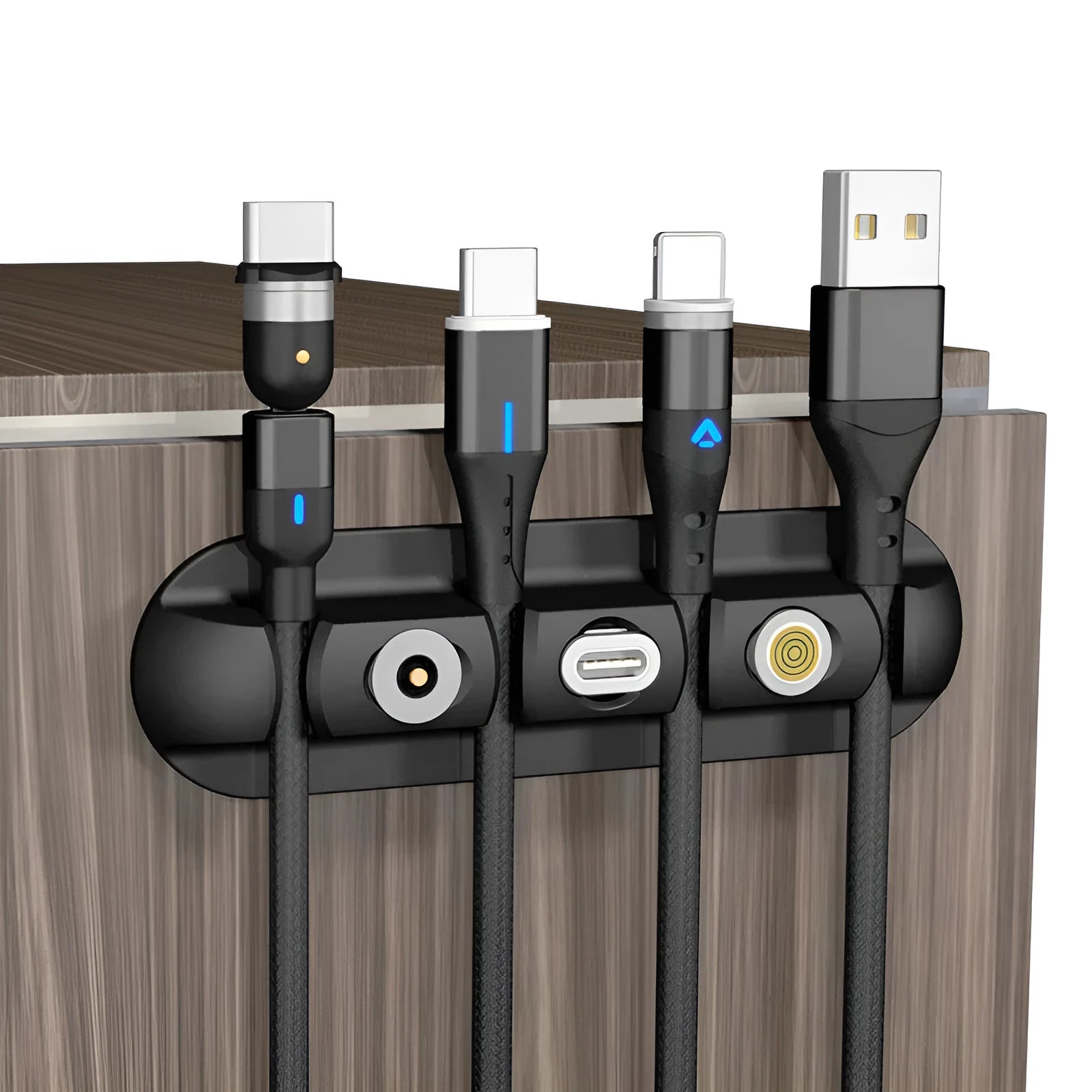 Black soft plastic desktop magnetic charging cable organiser on a desk.