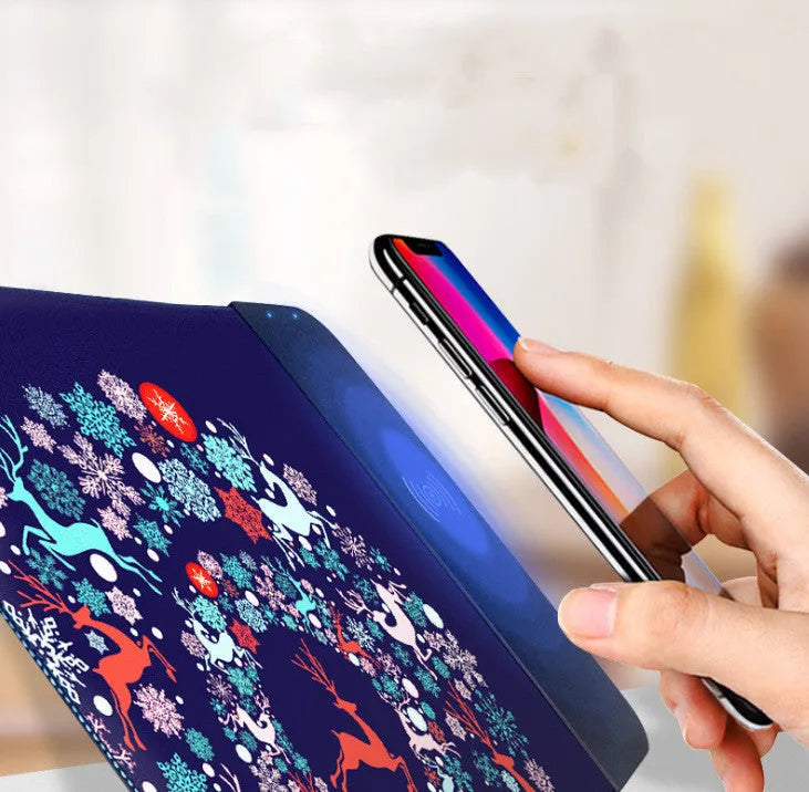 Colourful cartoon design wireless charging mouse pad with RGB lighting on a desk