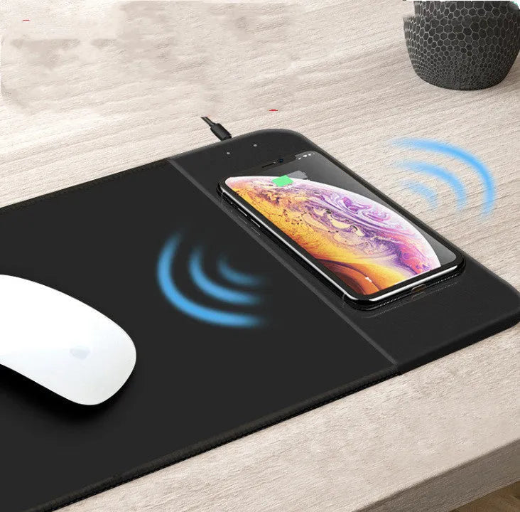 Colourful cartoon design wireless charging mouse pad with RGB lighting on a desk
