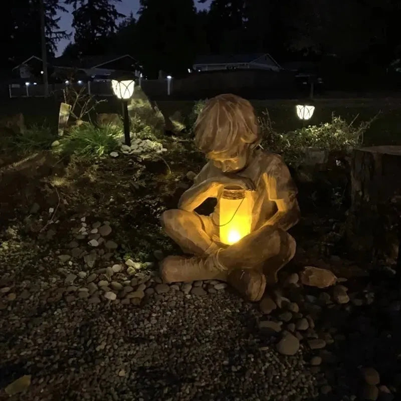 Brown natural resin tabletop statue of young boy in garden setting for indoor decoration