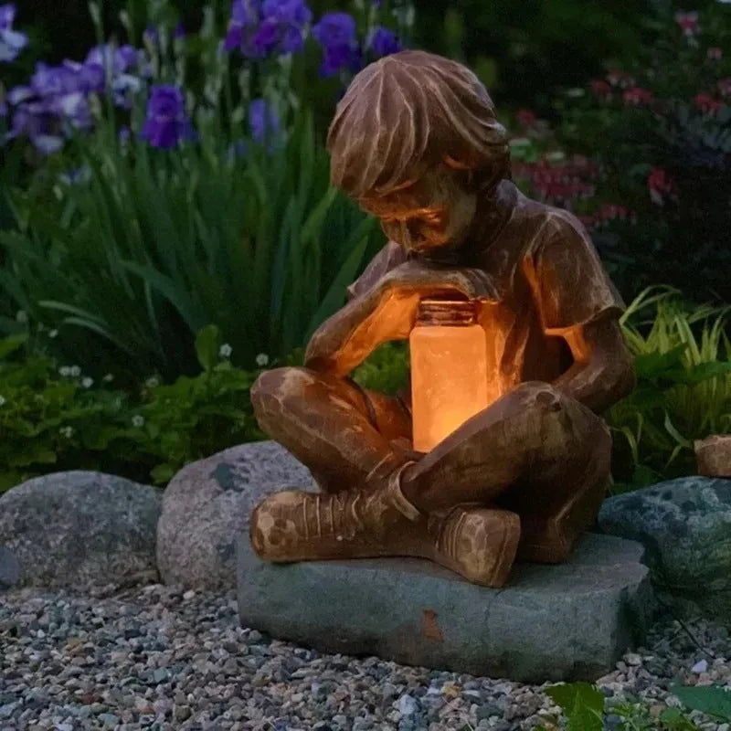 Brown natural resin tabletop statue of young boy in garden setting for indoor decoration
