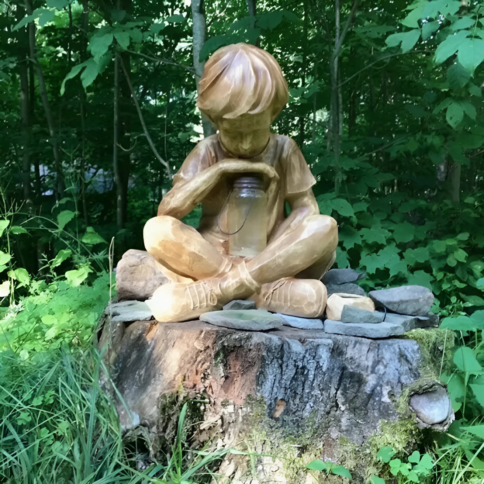 Brown natural resin tabletop statue of young boy in garden setting for indoor decoration