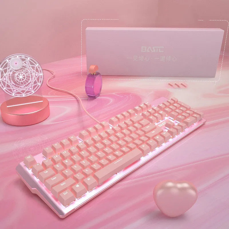 Pink-coloured wired mechanical keyboard and mouse set on a desk.
