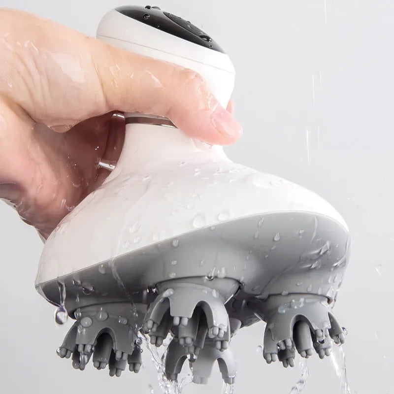 White rechargeable waterproof electric scalp head massager with wireless remote control on a surface