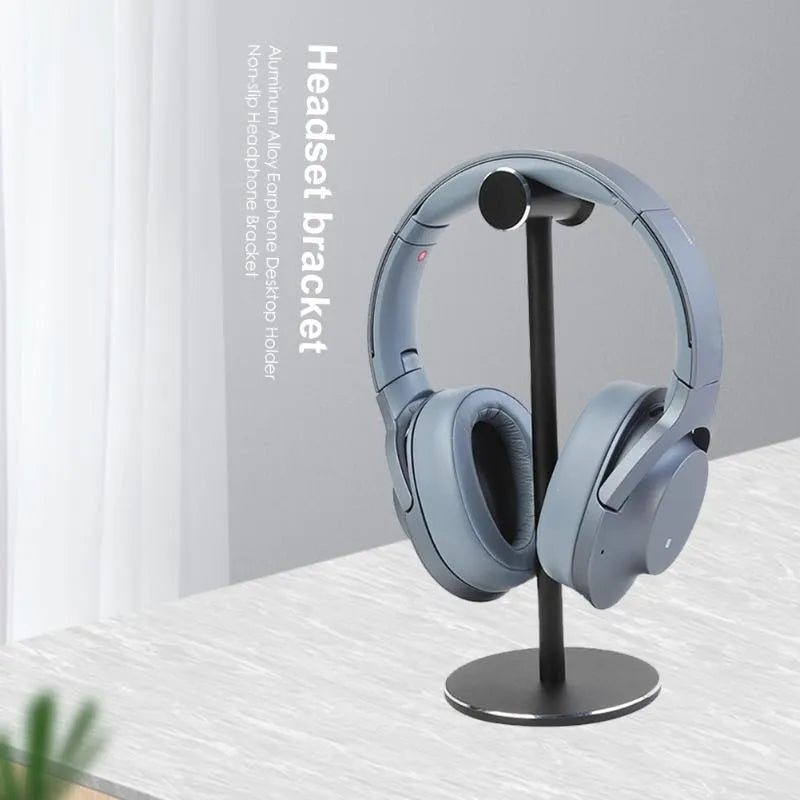 Black aluminium alloy headset bracket storage stand on a desk holding earphones