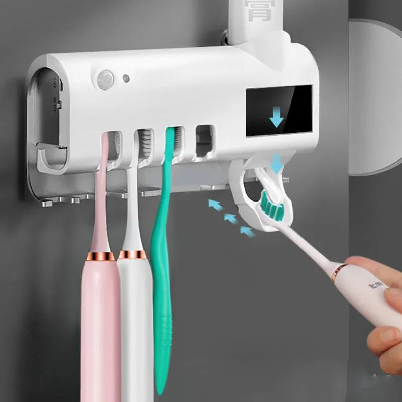 Automatic UV toothbrush steriliser with wall-mounted toothpaste squeezer in black or white