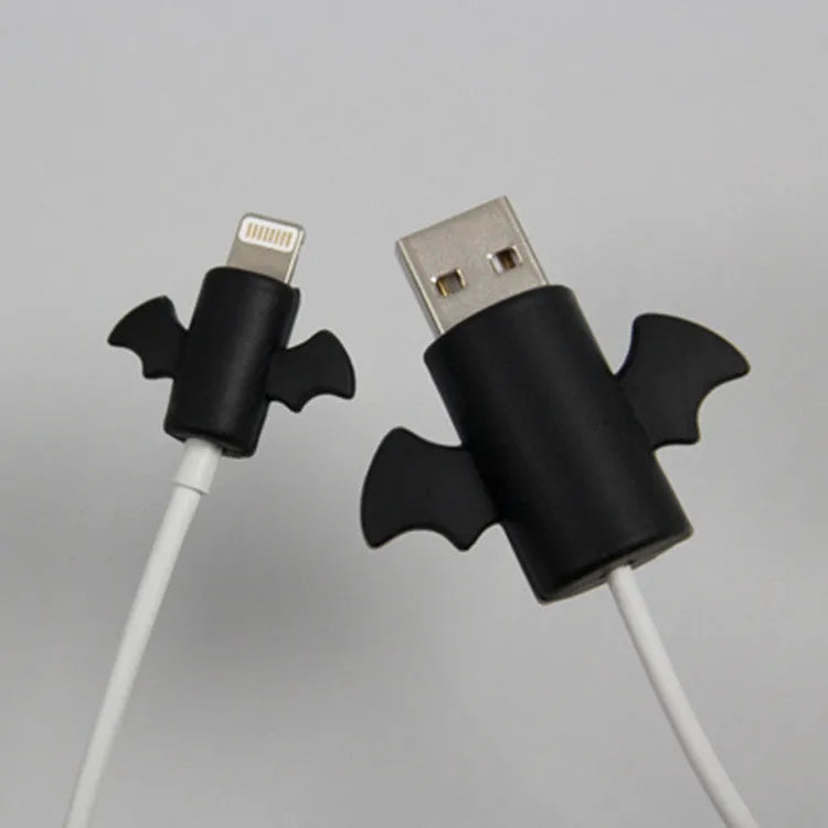 White and black silicone cable protective covers shown next to a mobile phone charging cable