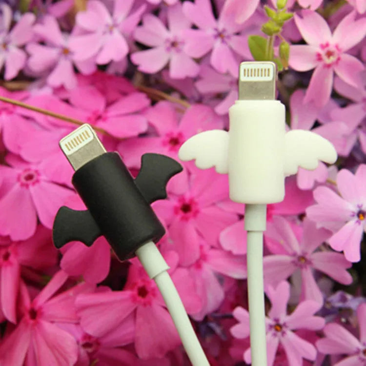 White and black silicone cable protective covers shown next to a mobile phone charging cable