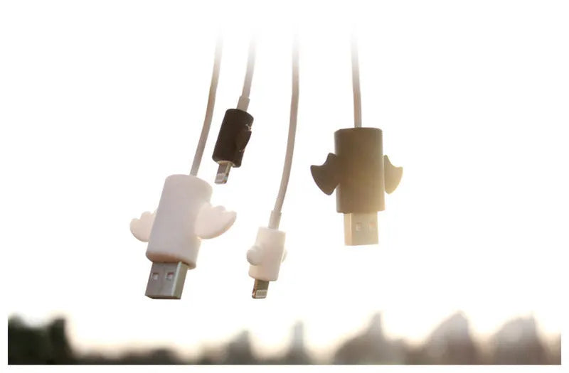 White and black silicone cable protective covers shown next to a mobile phone charging cable