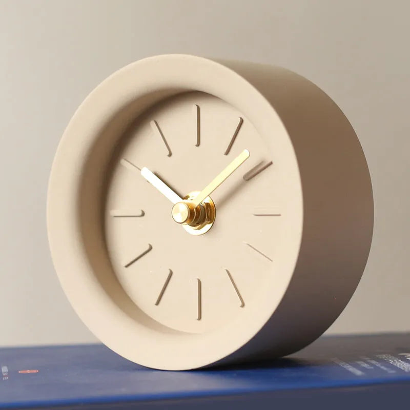 Round cement silent desk clock with Nordic minimalist design on wooden surface