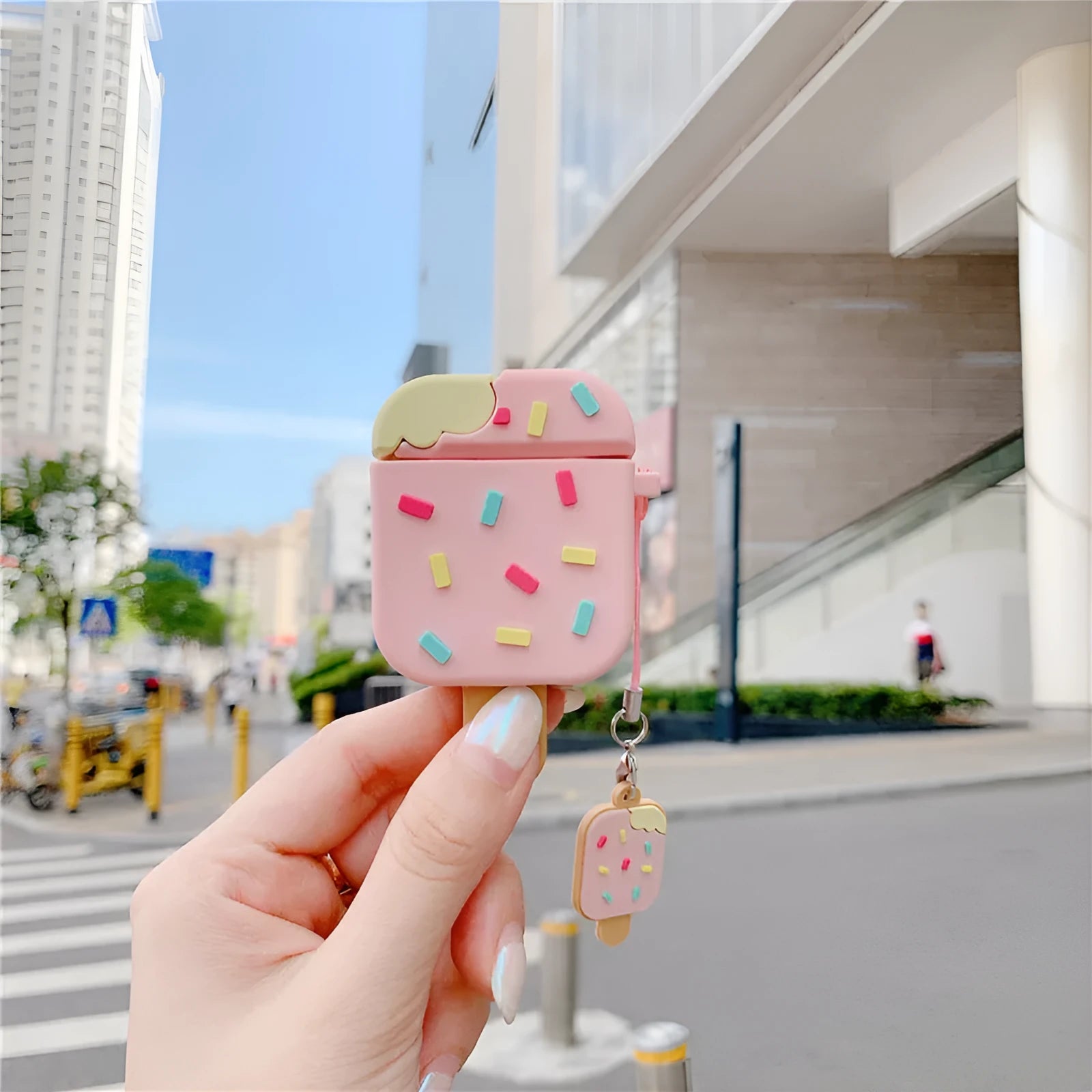 Pink cartoon ice cream design silicone protective case for Apple AirPods with a pendant.