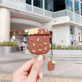 Silicone AirPods cover with anti-drop shell, flip-type ice cream design in pink or brown, and pendant