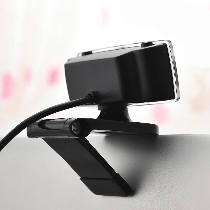 Black USB high definition webcam for desktop and laptop computers on a white background.