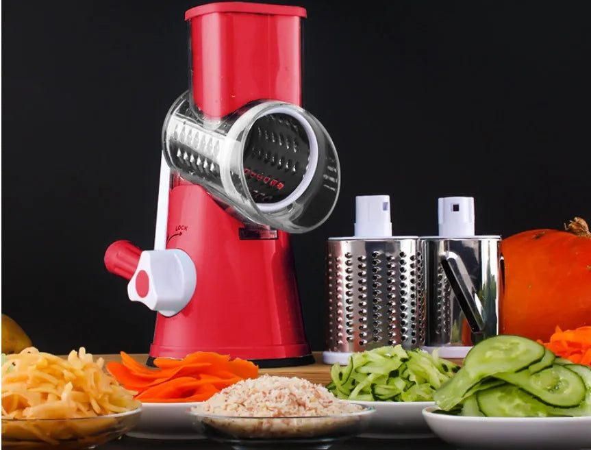 Blue green mandoline vegetable slicer with three stainless steel blades and a white suction cup base on a kitchen counter.