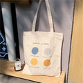 Women's medium canvas tote bag with zipper closure and geometric pattern in light pink