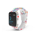Colourful printed silicone Apple Watch band showing tie-dye and leopard print patterns on a wrist.