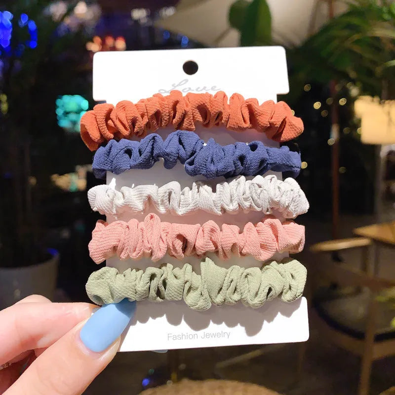 Assorted children's hair rings and head ropes in autumn colours and macaron pastels.