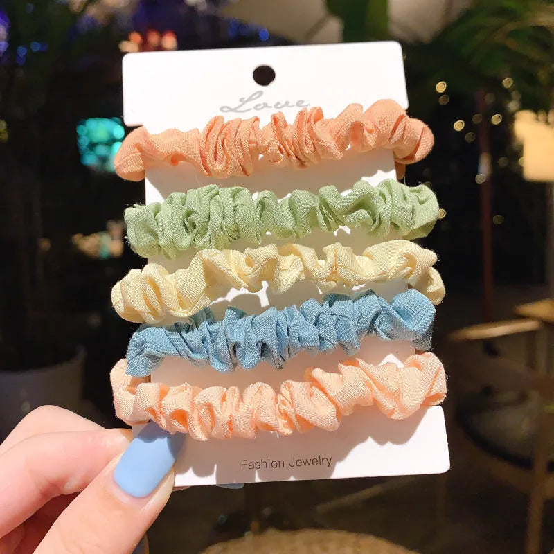 Assorted children's hair rings and head ropes in autumn colours and macaron pastels.