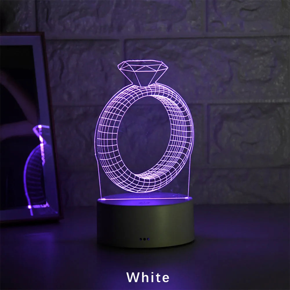 3D LED night light showing illuminated diamond ring design on black base with colour-changing glow