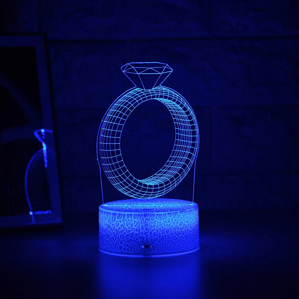 3D LED night light showing illuminated diamond ring design on black base with colour-changing glow