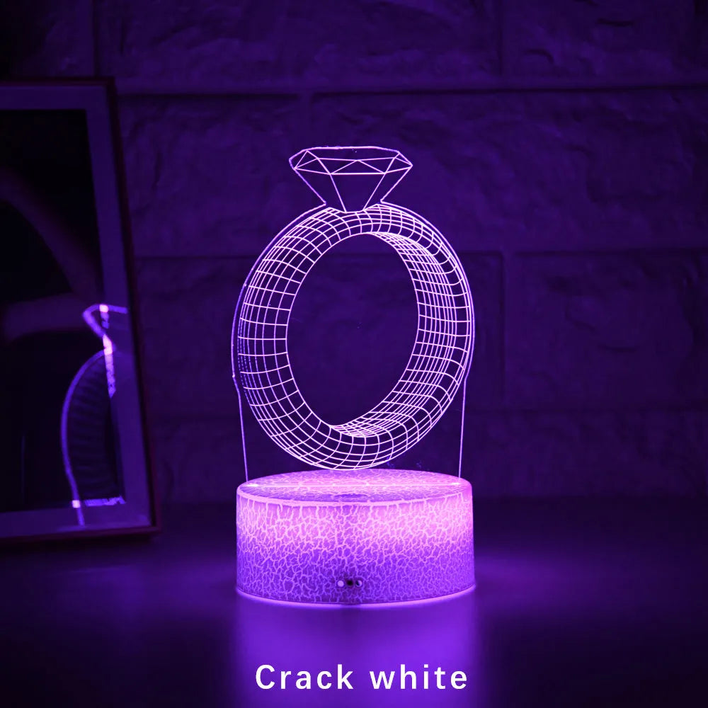 3D LED night light showing illuminated diamond ring design on black base with colour-changing glow
