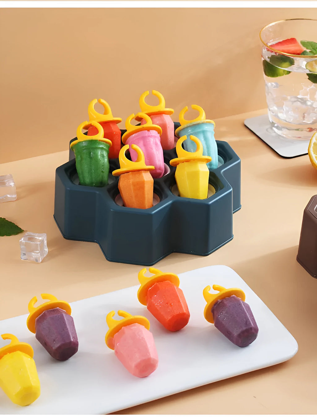 Soft plastic cartoon-style ice cube mould in brown and navy blue, showing honeycomb and rectangle shape options.